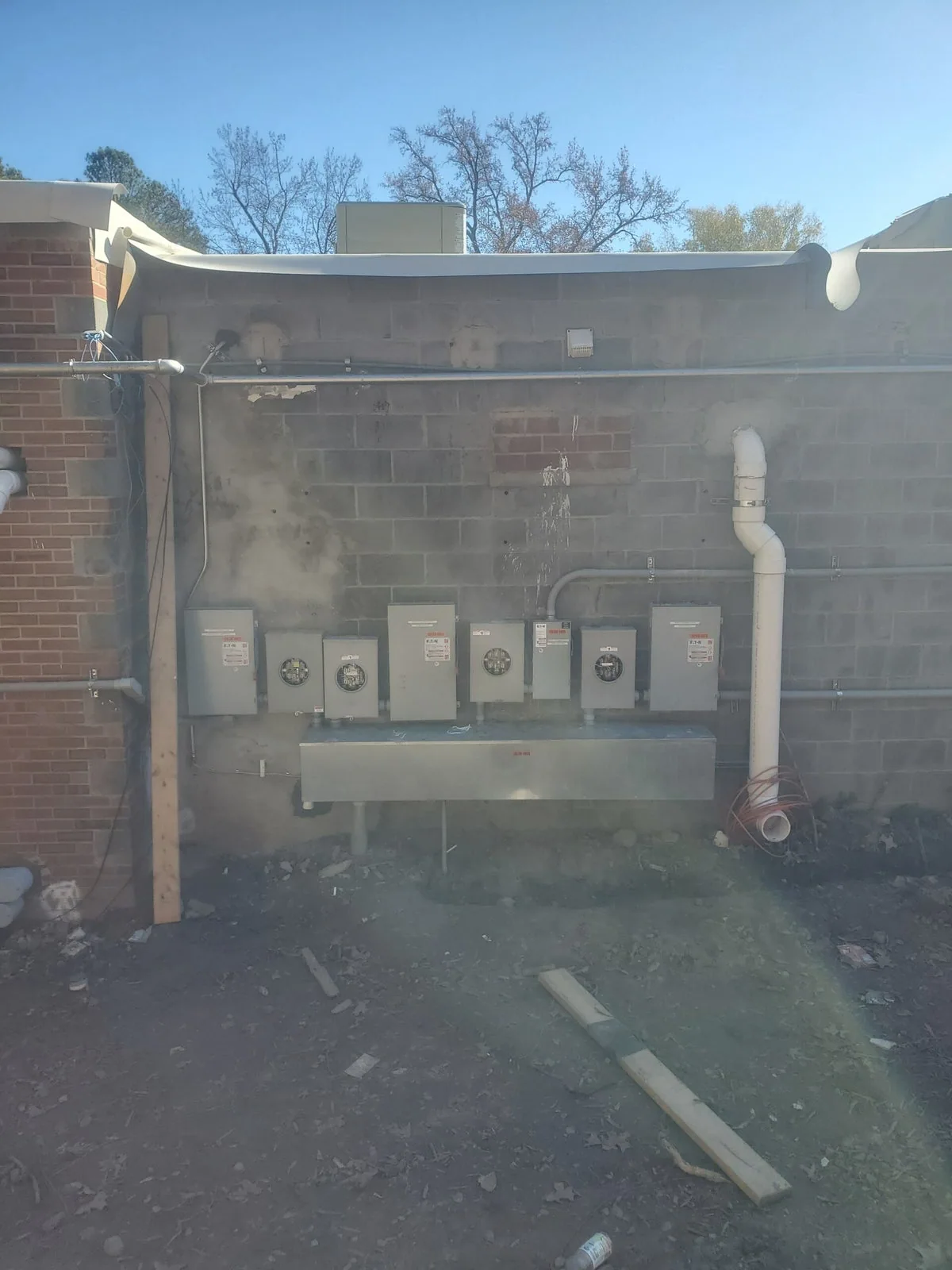 Multiple electrical meters and service equipment on a brick building, from Bahama Electric’s project photos